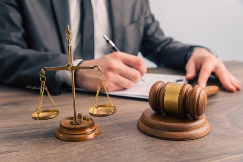 Law,And,Justice,Concept,,Lawer,Holding,Document,With,Wooden,Gavel
